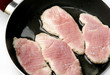 Food,four pork steaks roasting in pan