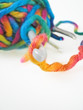 YARN WITH DIFFERENT SIZE OF CHROCHET HOOKS OVER WHITE