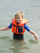 Boy wearing life jacket in water