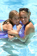 woman and little girl  in a swimming pool
