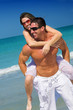 attractive man carrying woman at the beach attractive man carrying woman at the beach