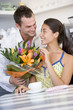 Man giving woman bouquet of flowers