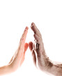 Hands of young woman and elderly man over white background Hands of young woman and elderly man over white background