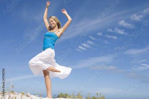 Photo: Young Woman on sand dune Young Woman on sand dune