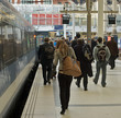 People rush from a train to their jobs