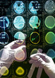 Photo: Test tubes in a scientist's hand on scan images Test tubes in a scientist's hand on scan images