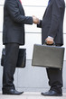 Detail of 2 businessmen meeting outside office