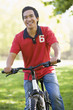 Photo: Asian man riding bike in park Asian man riding bike in park