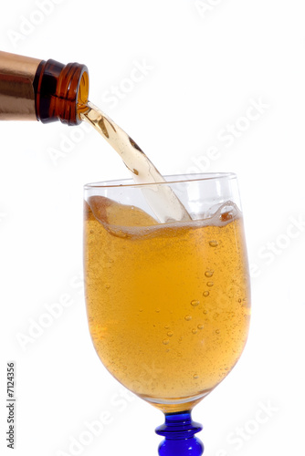 Photo: Bottle of cold beer filling the glass Bottle of cold beer filling the glass
