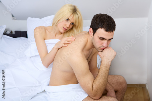 Photo: Tender look of a girl to her friend in bedroom, focus on female Tender look of a girl to her friend in bedroom, focus on female