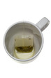 Teabag in an empty cup isolated on white background