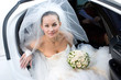 bride with flowers in the white car