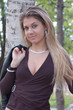 Pretty  blonde girl near of birch tree