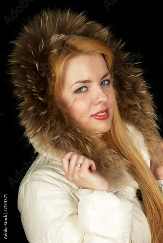 Photo: Teen-age girl in jacket on black background. Teen-age girl in jacket on black background.