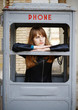 Foto: lonely girl in old phonebox lonely girl in old phonebox