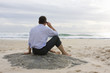 Businessman with cell phone on beach
