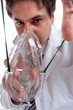 Doctor or anesthetist placing oxygen mask on patient