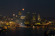 Full Moon over City buildings
