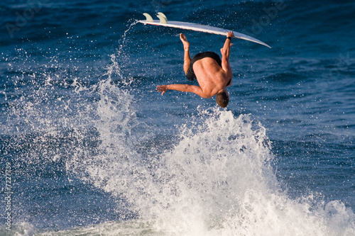 Photo: Surfer inverted 180 degrees off of a wave Surfer inverted 180 degrees off of a wave