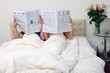 Couple reading newspapers 2