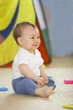 smiling baby boy with toys