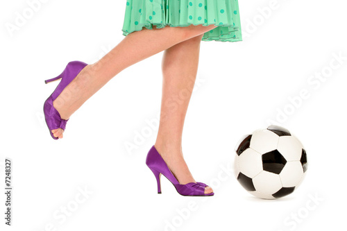 Photo: Woman with high heels kicking a soccer ball Woman with high heels kicking a soccer ball