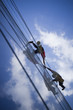 Two persons climbing building