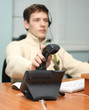 Call center operator answering a call, focus on the receiver Call center operator answering a call, focus on the receiver