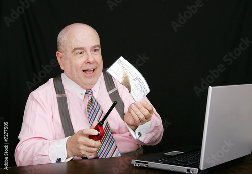 Photo: business man burning a check business man burning a check