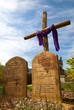 Leinwandbild Motiv A cross with the ten commandments in stone in front of it.