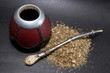 Сup from calabash with straw.