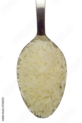 Photo: Spoonful of long grain rice isolated on white background Spoonful of long grain rice isolated on white background