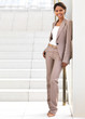Smiling businesswoman standing against wall