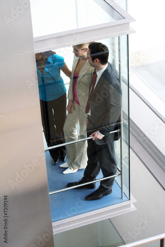 Photo: business team is talking in a elevator business team is talking in a elevator