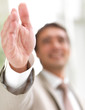 Portrait of a businessman, open hand