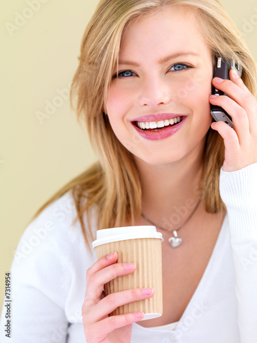 Photo: Young woman using mobile phone Young woman using mobile phone