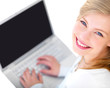 Young smiling teenager working on laptop