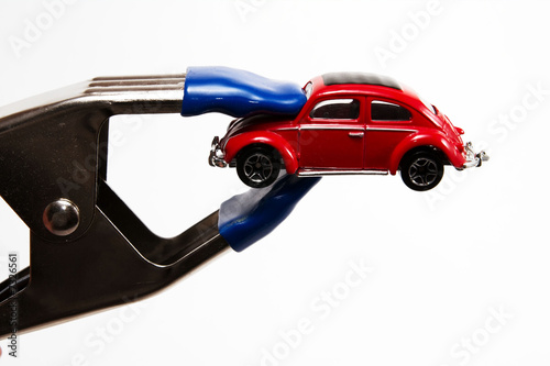 Photo: A red car feeling the pinch of high gas prices. A red car feeling the pinch of high gas prices.