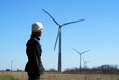 Woman engineer or architect with white safety hat and wind turbi