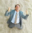 Photo: Extremely excited business man in the sand Extremely excited business man in the sand