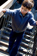 Little boy  walking across a suspended bridge 