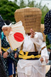Young boy performing wearing wicker basket mask in Japan