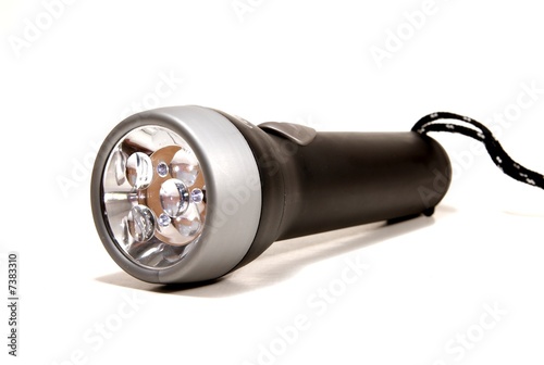 Photo: a black flashlight torch on a white seemless background. a black flashlight torch on a white seemless background.