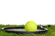 Tennis racket and ball on grass