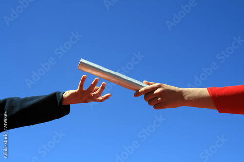 hands passing the batton