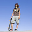 Teen skater atop ramp