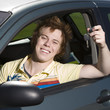 Happy teen in car with keys