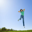 Happy teen jumps in air.