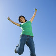 Happy teen jumps in air.
