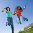 Happy teens jump in air.